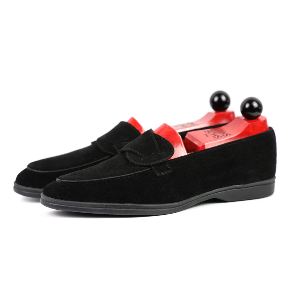 Black suede loafers with red insoles and black shoe trees.