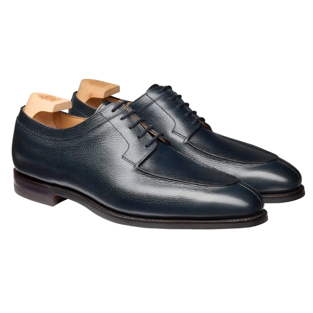 A pair of dark blue leather dress shoes with a smooth finish and light-colored laces.