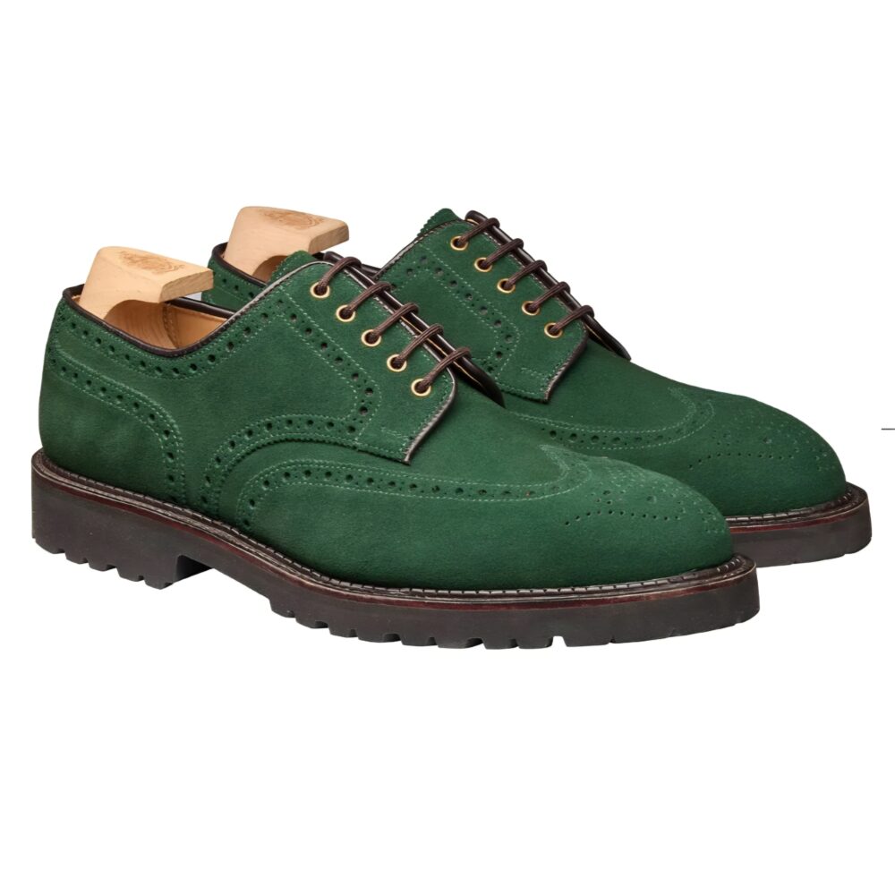 Green suede brogue shoes with brown laces and a thick black sole.