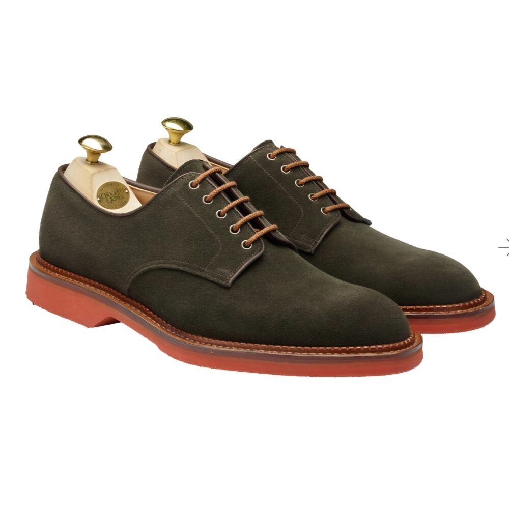 A pair of dark green suede shoes with brown laces and a reddish-brown sole.