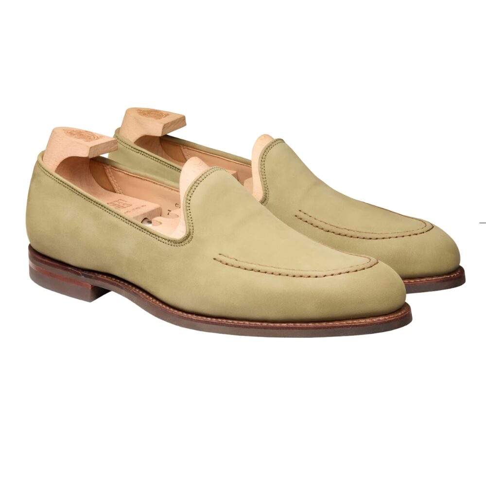 A pair of green suede loafers with a smooth finish and stitched detailing.