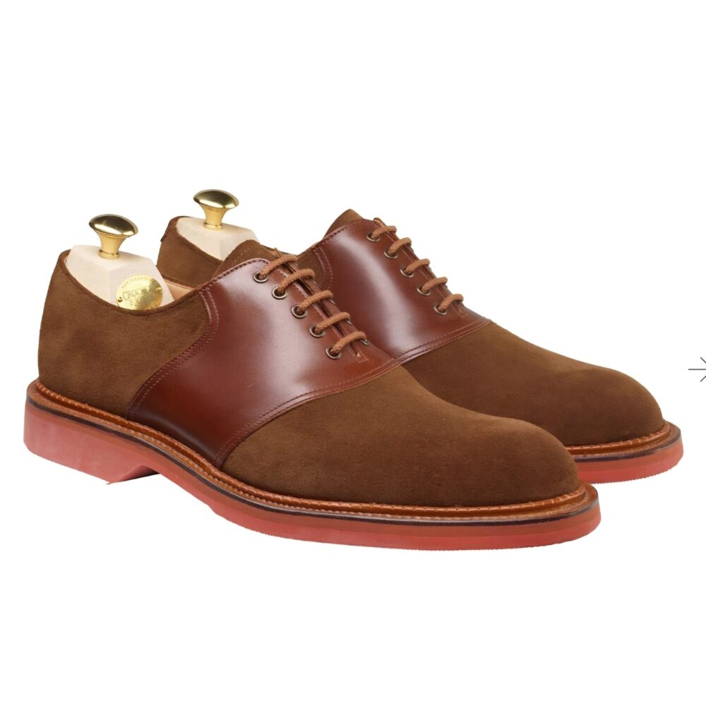 Brown suede shoes with a leather panel and a red rubber sole.