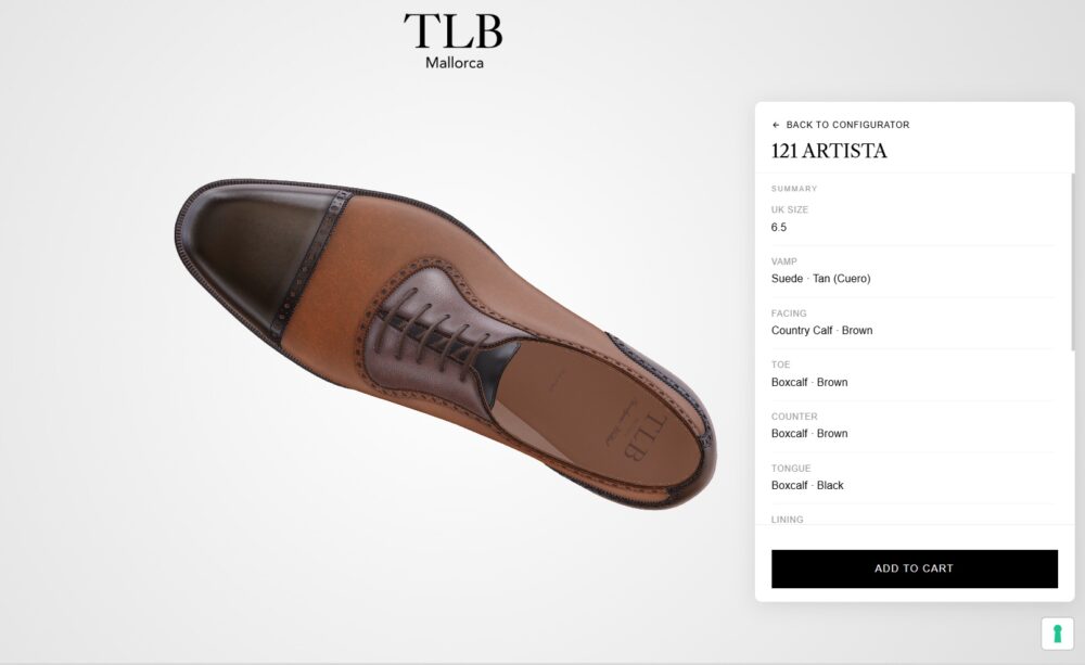 A brown and black leather dress shoe with a suede vamp and intricate detailing on the toe.