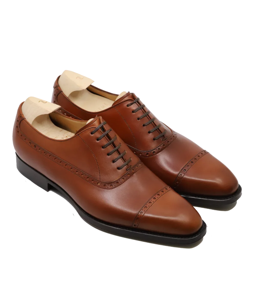 A pair of polished brown leather dress shoes is featured for the Septieme Largeur Summer Sale 2026.