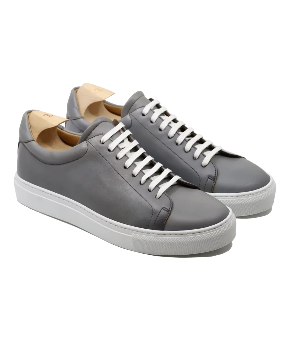 Gray leather sneakers with white laces featured in the Septieme Largeur Summer Sale 2026.