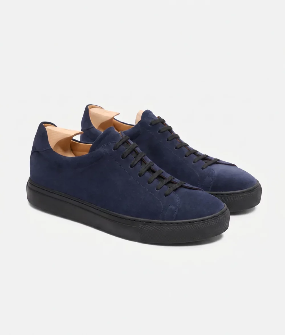 Navy blue suede sneakers with black laces featured in the Septieme Largeur Summer Sale 2026.