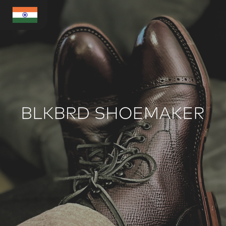 A close-up of polished brown leather boots with intricate lacing.