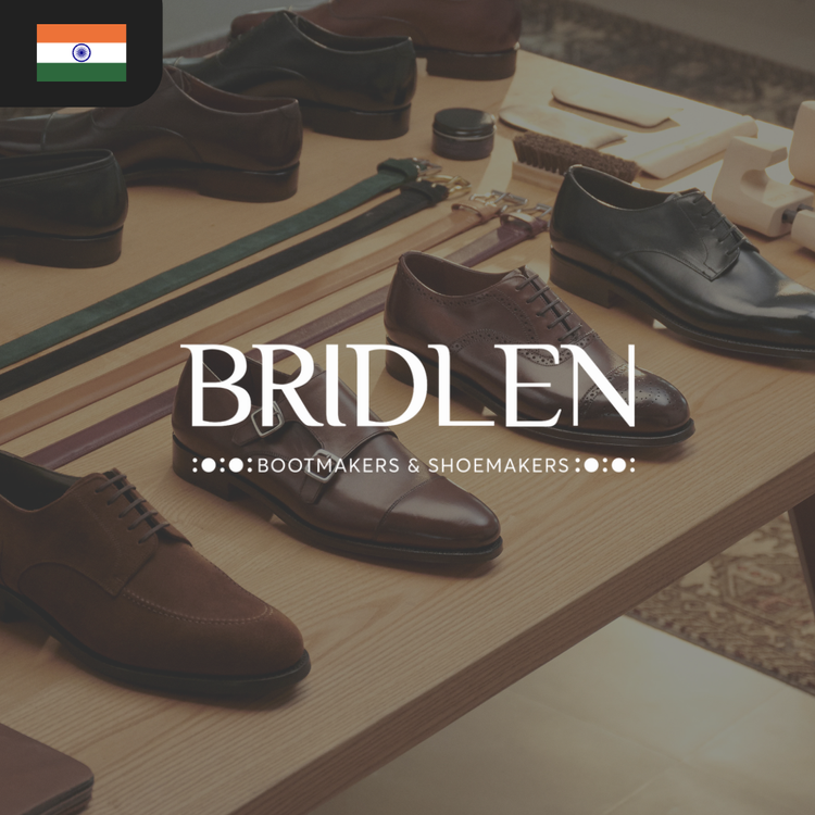 A variety of leather shoes in brown and black displayed on a wooden table, featuring the text "BRIDLEN Bootmakers & Shoemakers."