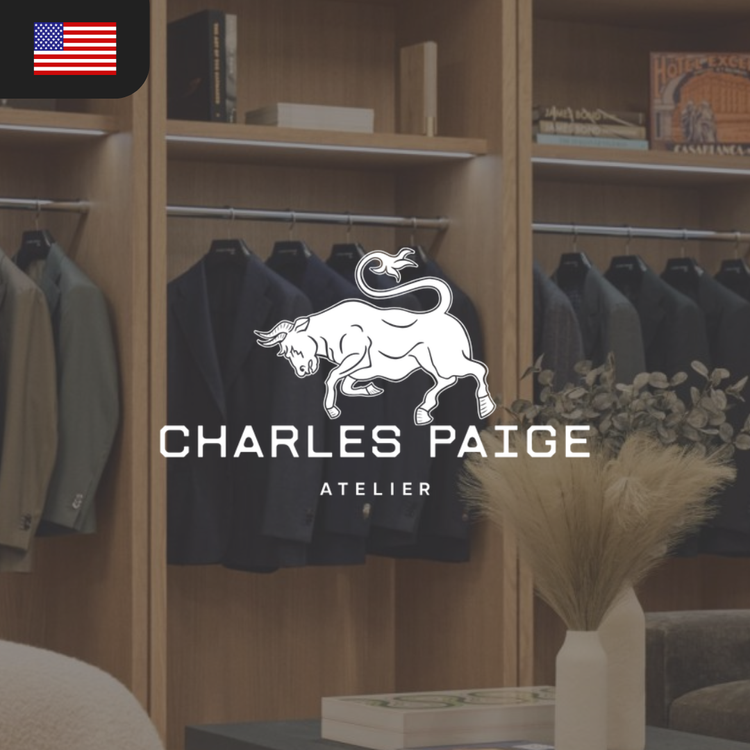 Logo of Charles Paige Atelier featuring a bull and the brand name in bold letters, with a backdrop of clothing.