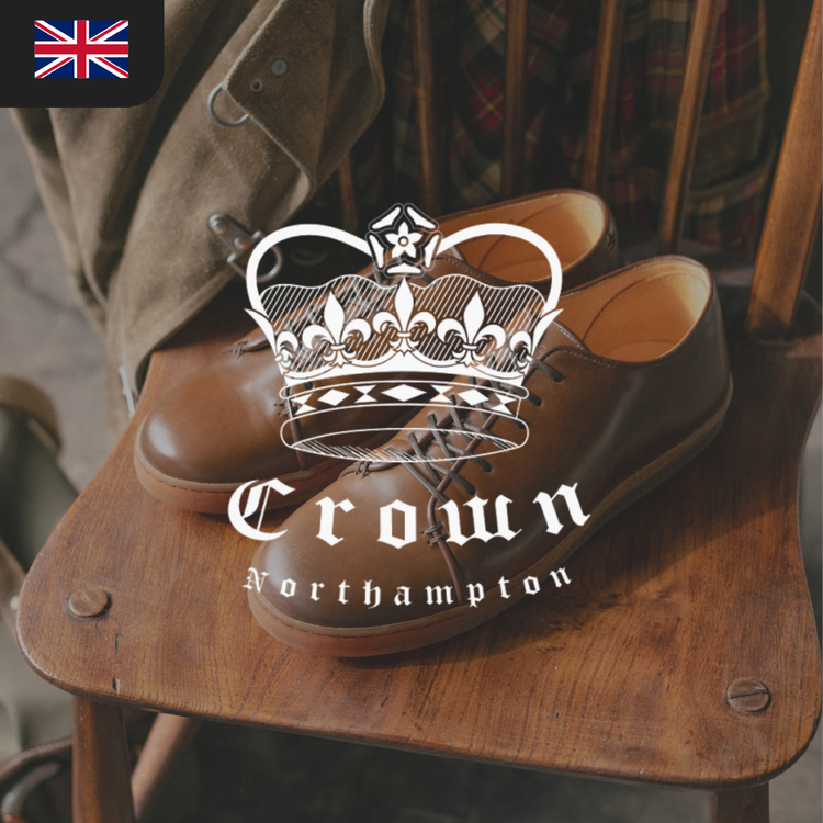 A pair of brown leather shoes with laces displayed on a wooden chair, featuring the "Crown Northampton" logo.
