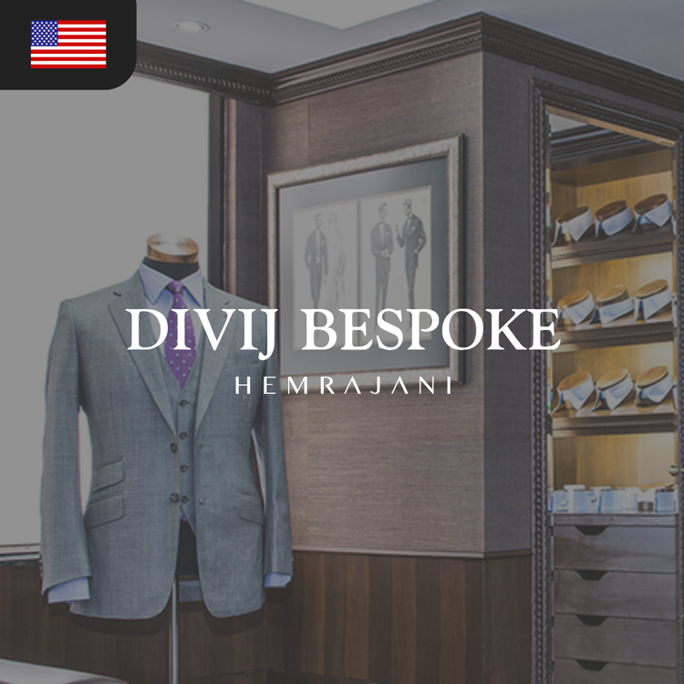 Gray tailored suit displayed on a mannequin with a purple tie, accompanied by a framed photo of formal wear.