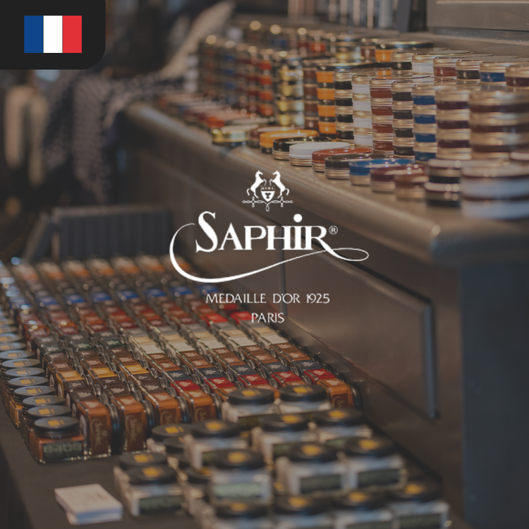 A display of colorful shoe care products in small jars, featuring the Saphir brand logo.