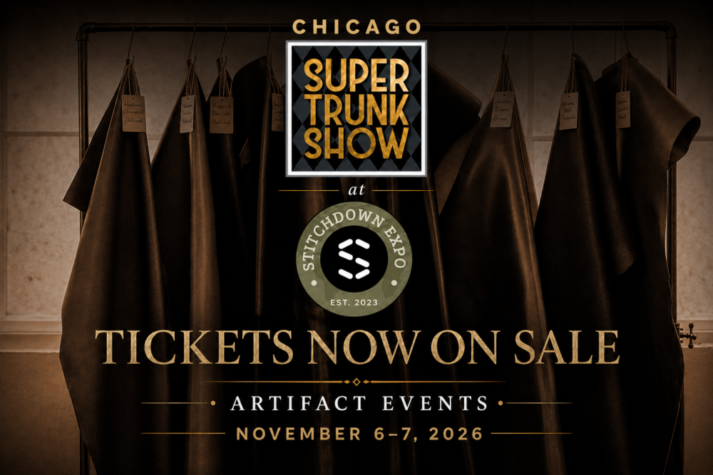 A collection of dark leather pieces hangs from a rack, each labeled with different colors and textures, promoting the Super Trunk Show at Stitchdown Expo.