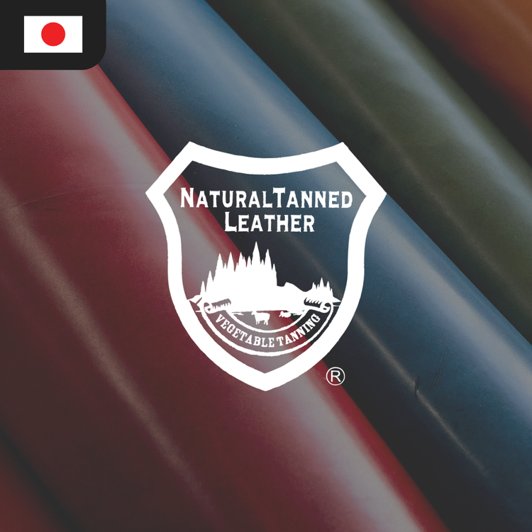 Logo for Natural Tanned Leather featuring a shield design with the text "Natural Tanned Leather" and "Vegetable Tanning" over colorful leather rolls in shades of red, brown, and green.