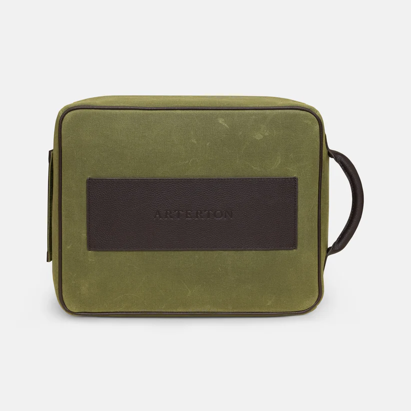 The Arterton Signature Shoe Bag is a rectangular green travel bag with a dark brown leather accent.