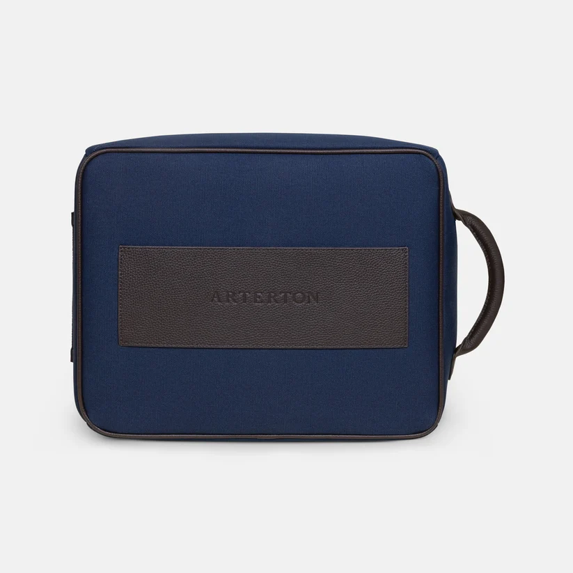 A navy blue Arterton Signature Shoe Bag with a brown leather accent displaying the brand name.