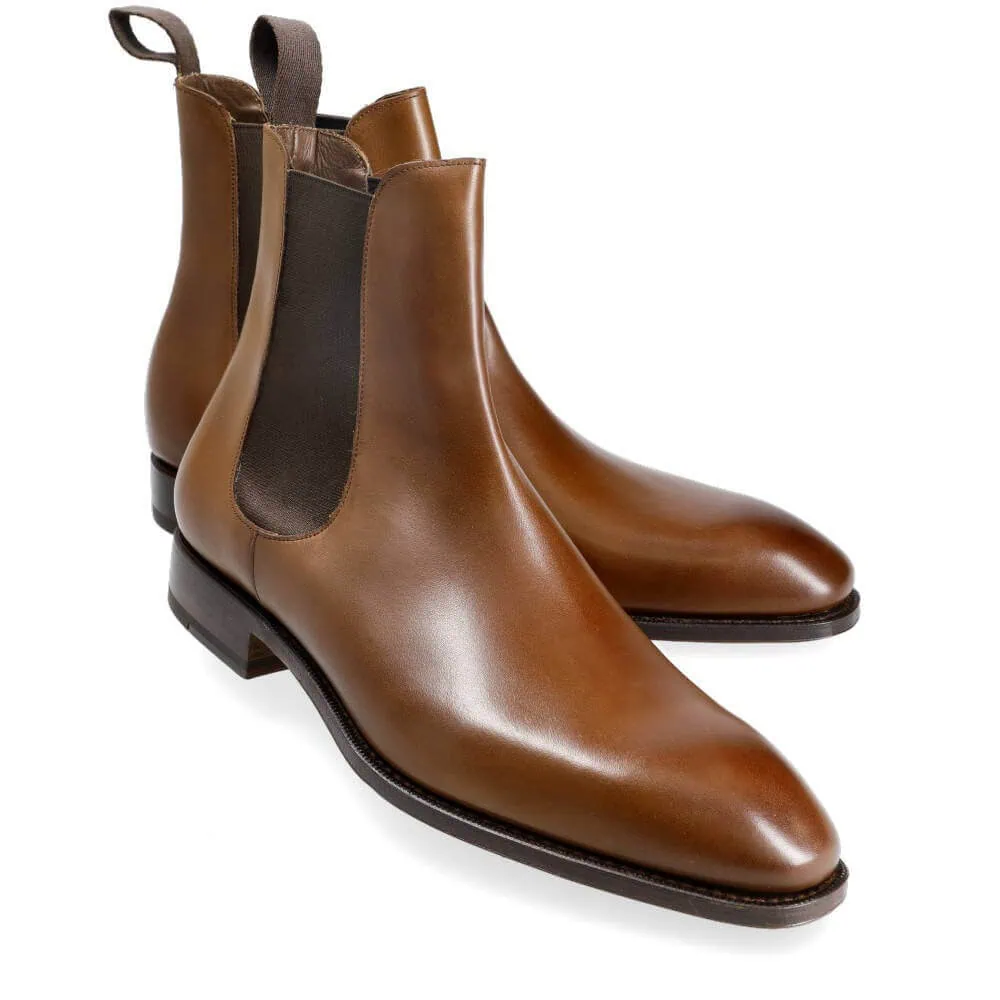 Brown leather Chelsea boots with elastic side panels.
