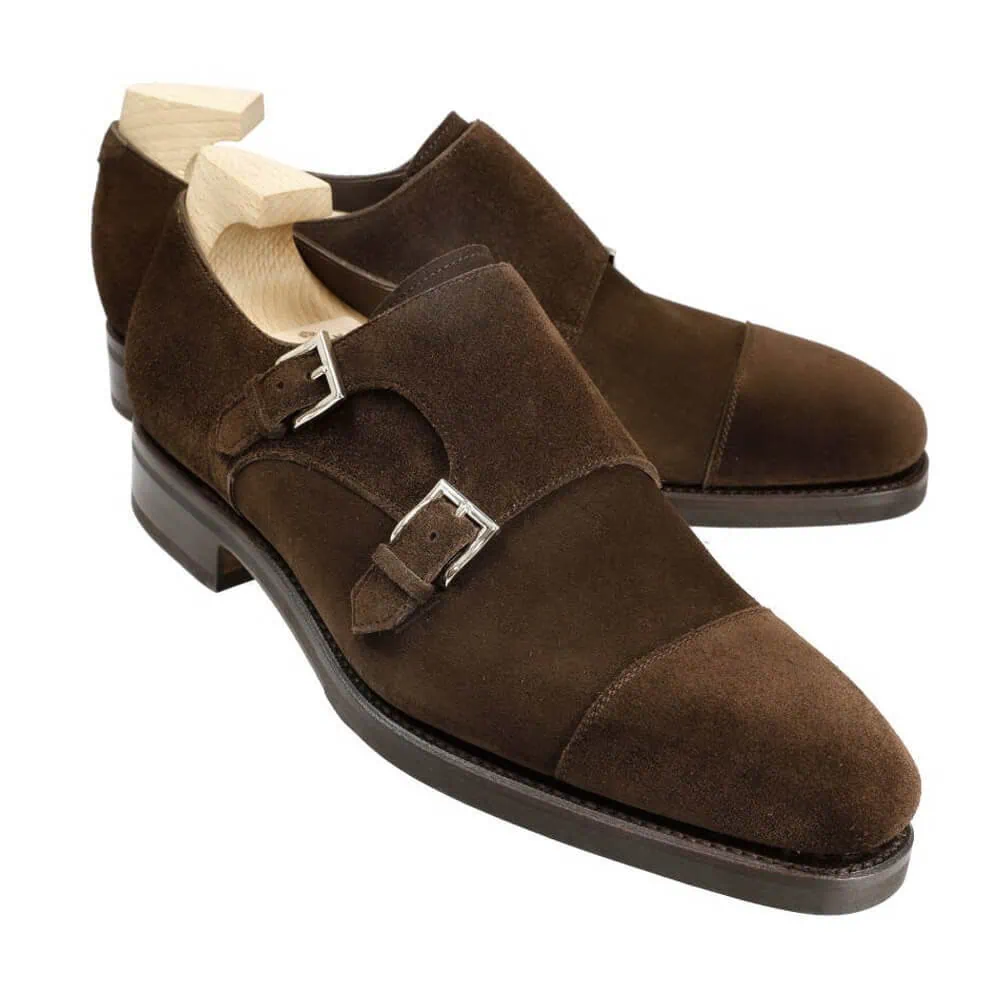Brown suede double monk strap shoes with silver buckles.