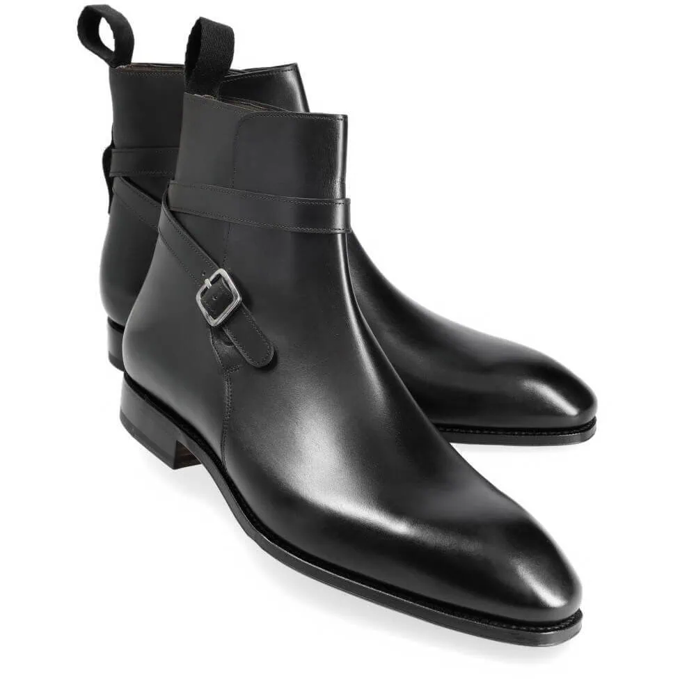 A pair of black leather ankle boots with a sleek design and a buckle detail.