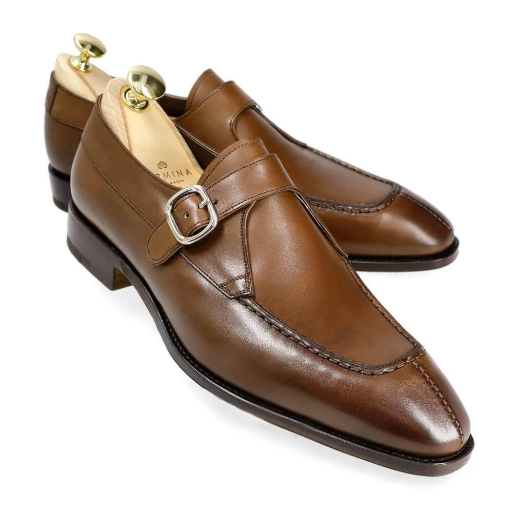 Brown leather dress shoes with a buckle detail.