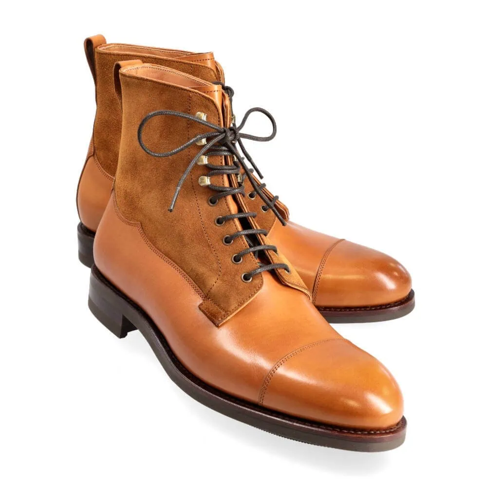 Tan leather and suede ankle boots with a rounded toe and lace-up design.