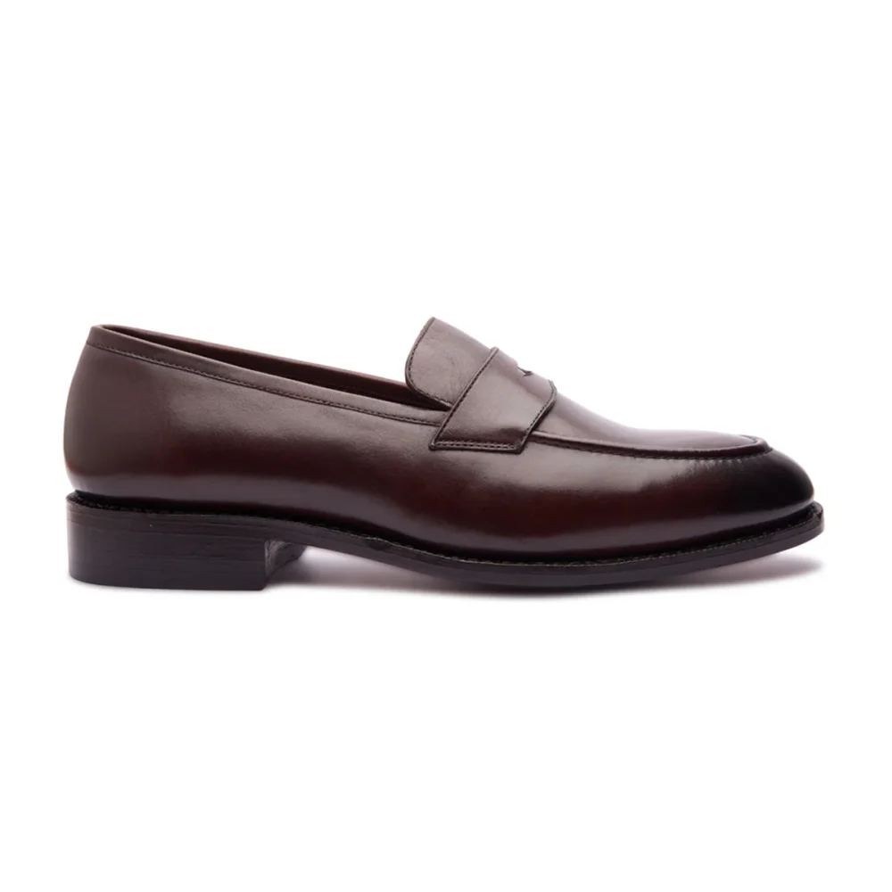 Brown leather loafer with a rounded toe and a low stacked heel.