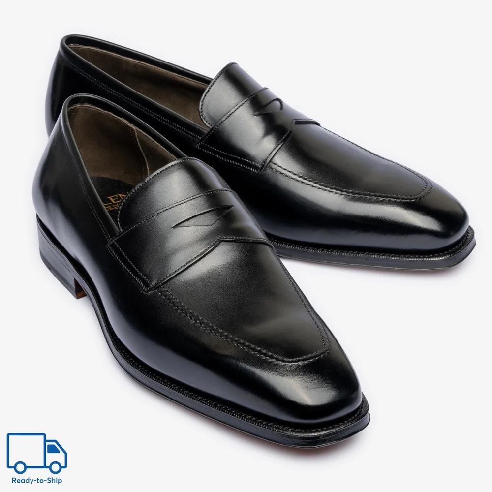 Black leather loafers with a sleek design and subtle stitching details.
