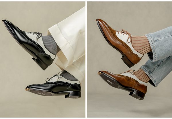 A pair of stylish dress shoes, one black and white and the other brown and white, are shown with coordinating socks.