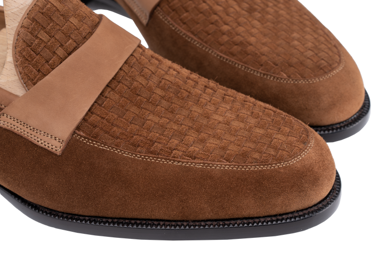 Close-up of brown suede Amalfi loafers with a woven texture and leather strap.