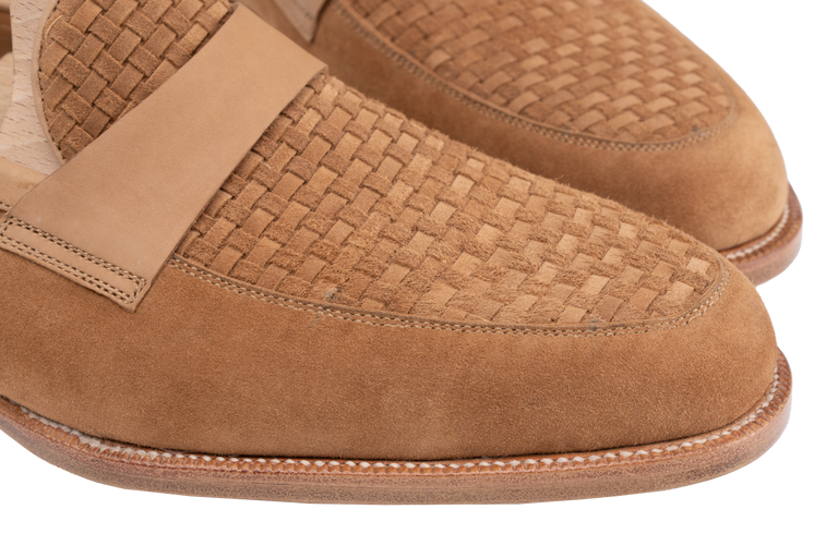 Close-up of brown suede Amalfi loafers with a woven texture on the front and a smooth leather strap.