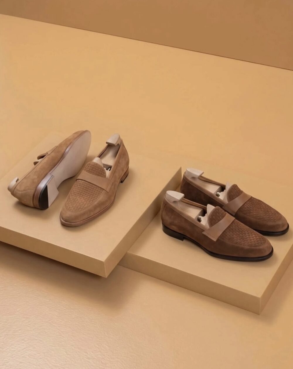 Two pairs of Amalfi loafers in shades of brown suede, featuring woven detailing and leather accents.