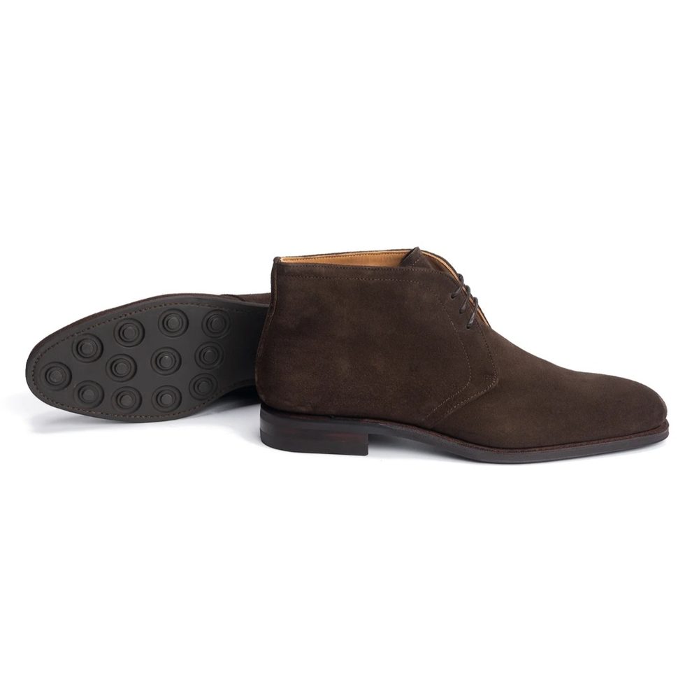 Brown suede ankle boots with a rubber sole and lace-up design.
