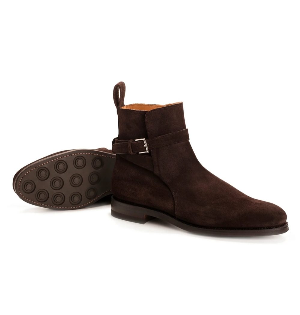 Brown suede ankle boots with a side buckle and a rubber sole.
