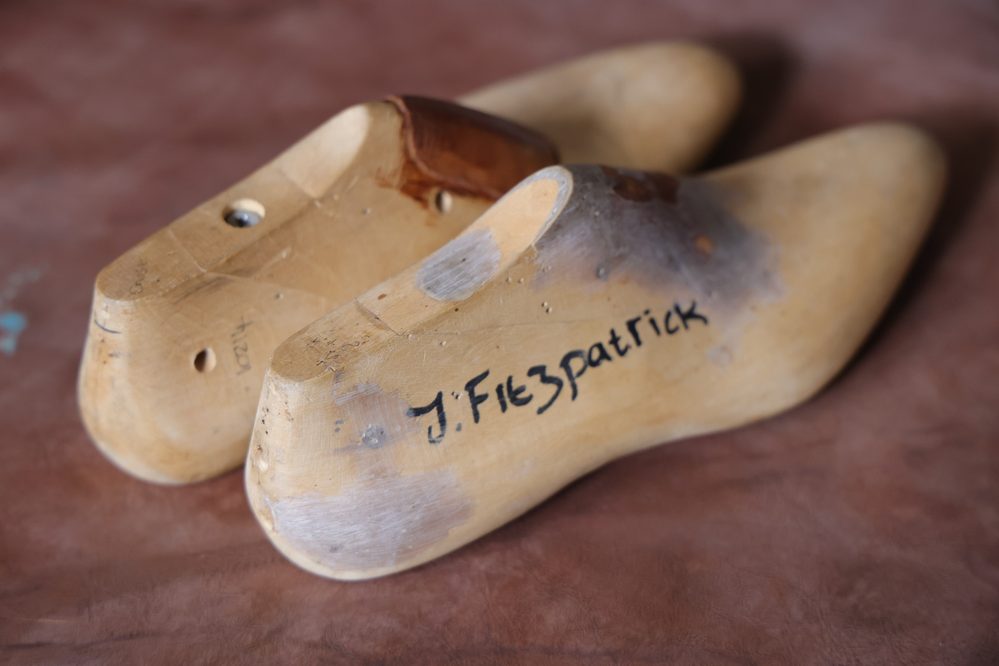 A wooden shoe last with markings, illustrating the concept of "what is a shoe last."