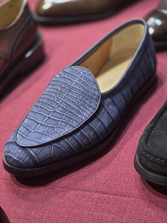 A navy blue crocodile nubuck loafer with a smooth finish and rounded toe.