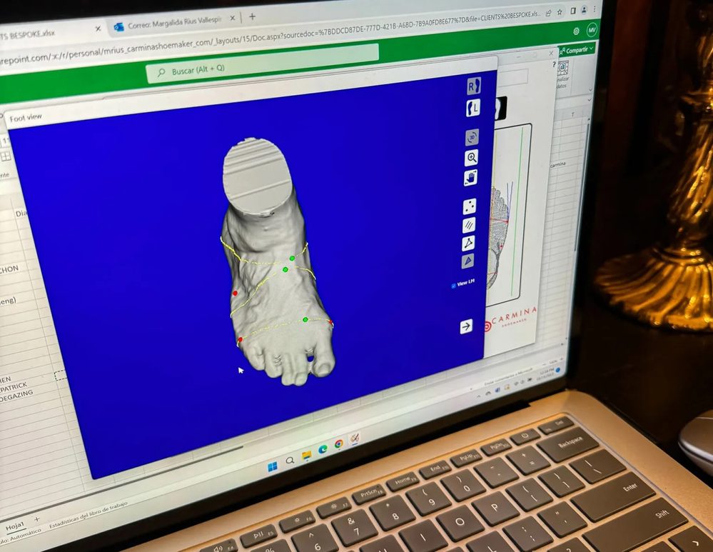 3D scan of a foot displayed on a laptop screen, part of the Carmina Bespoke Trunk Show process.