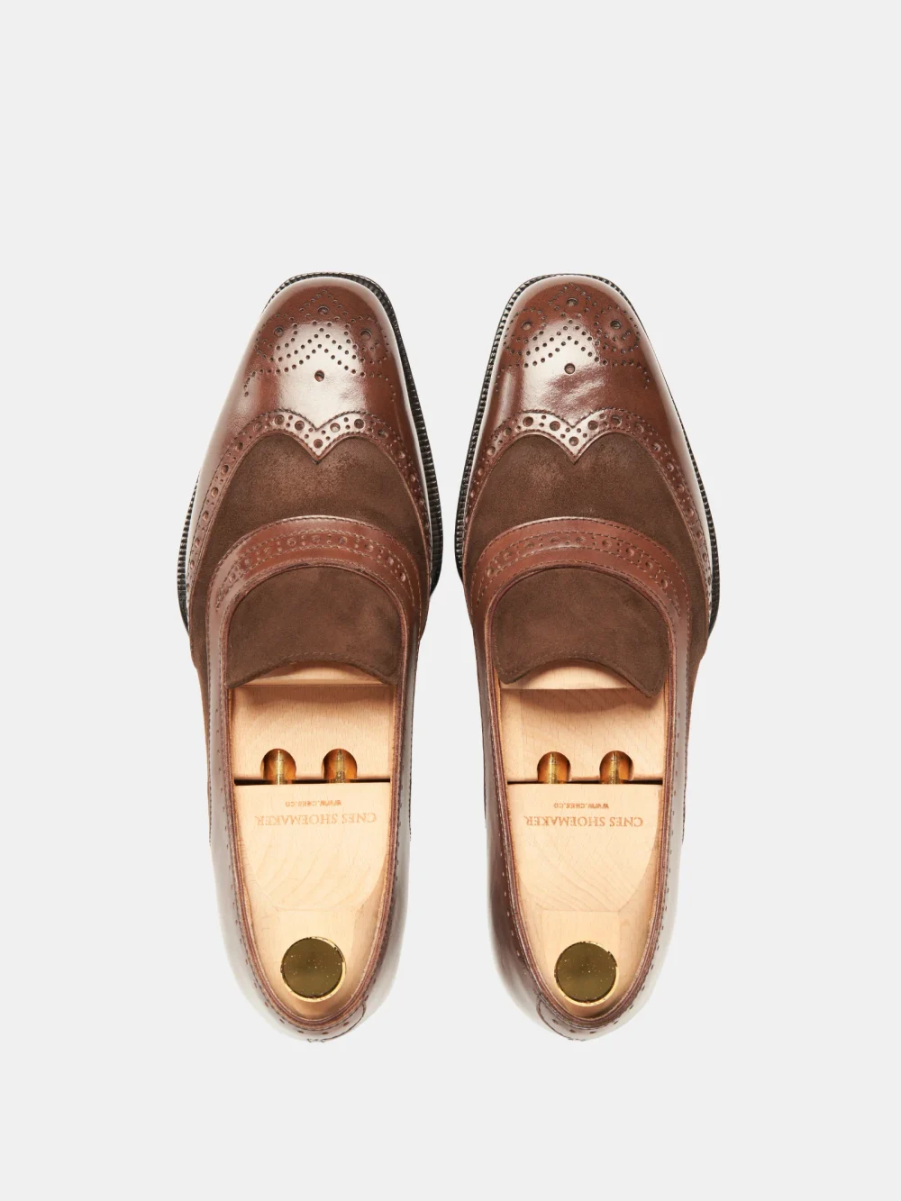Brown crocodile nubuck shoes with a glossy leather trim and decorative perforations.