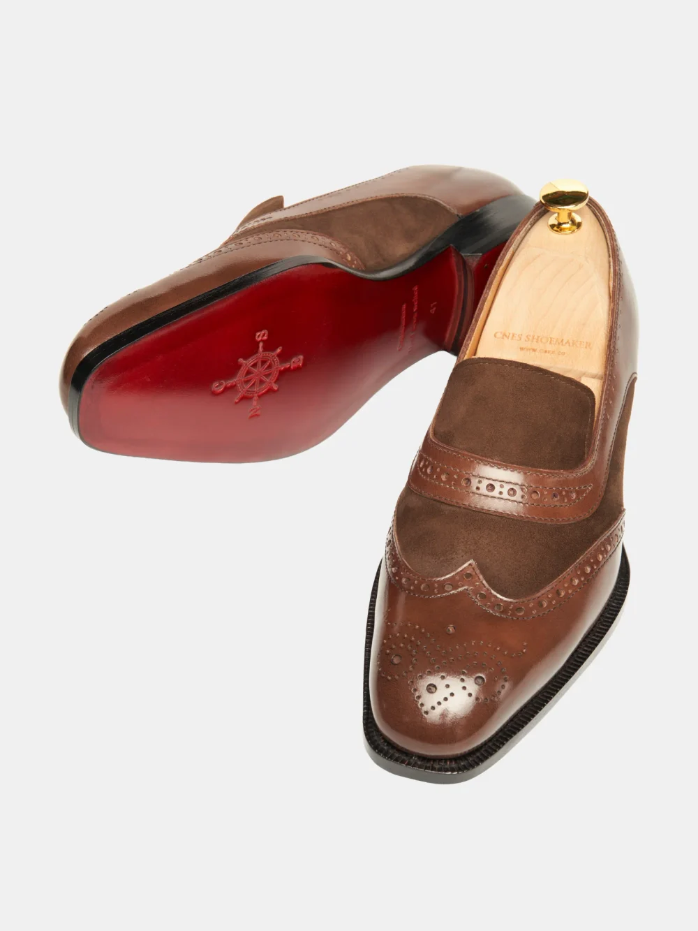 Brown crocodile nubuck shoes with decorative perforations and a shiny toe.