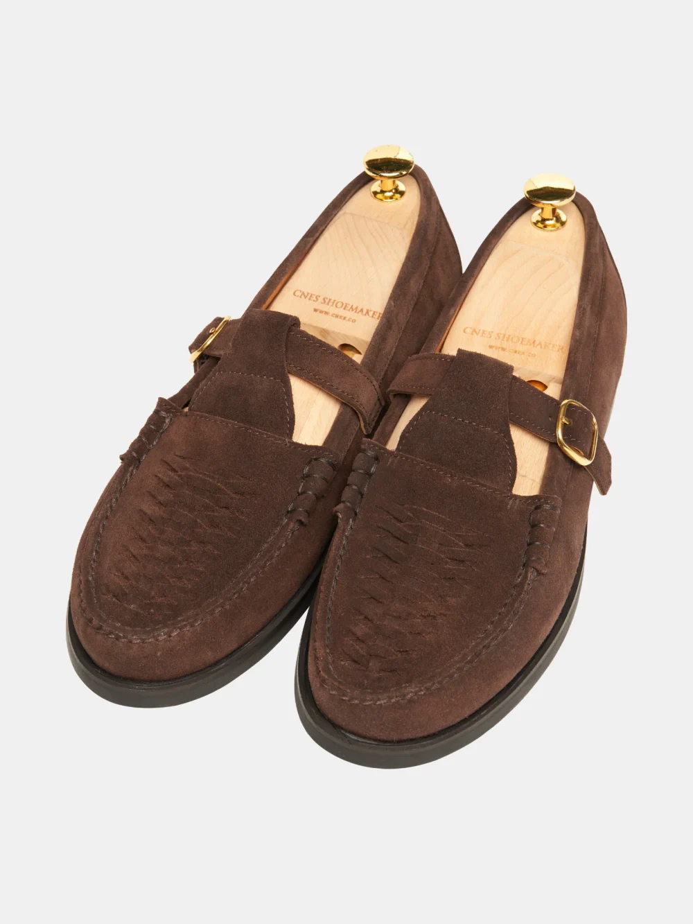 Brown crocodile nubuck loafers with a strap and gold buckle.