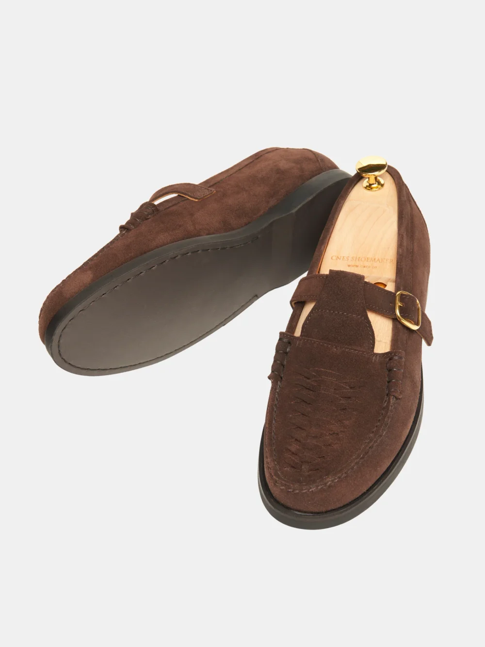 Brown crocodile nubuck loafers with a gold buckle detail.