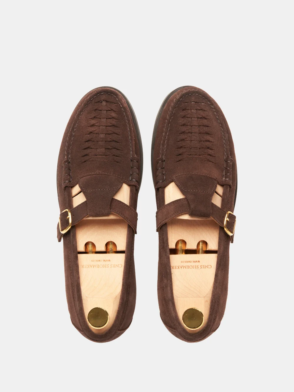 Brown crocodile nubuck loafers with a strap and buckle detail.
