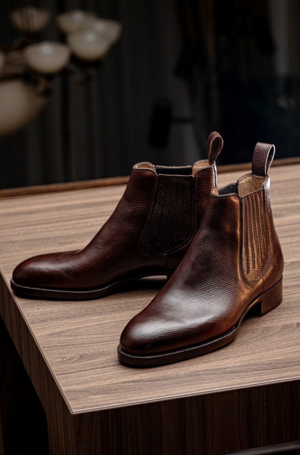 Brown handmade leather ankle boots with elastic side panels and pull tabs.