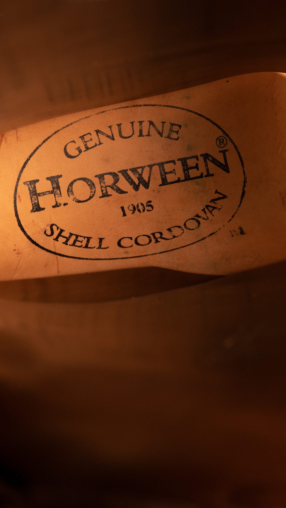A close-up of a label reading "Genuine Horween 1905 Shell Cordovan," featured in the Carmina Bespoke Trunk Show.
