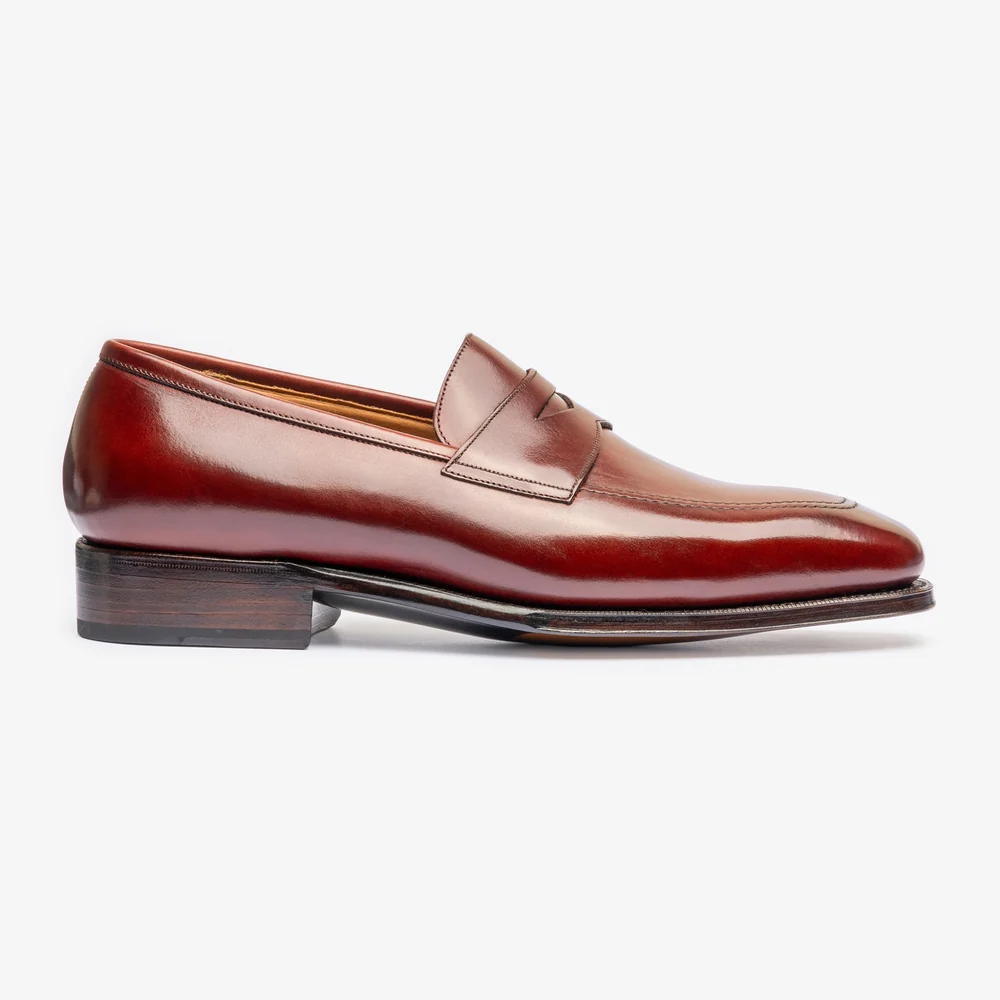 A burgundy leather loafer with a sleek design and a wooden heel.