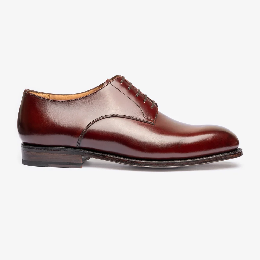 A sleek pair of burgundy shoes with a polished leather finish and a lace-up design.
