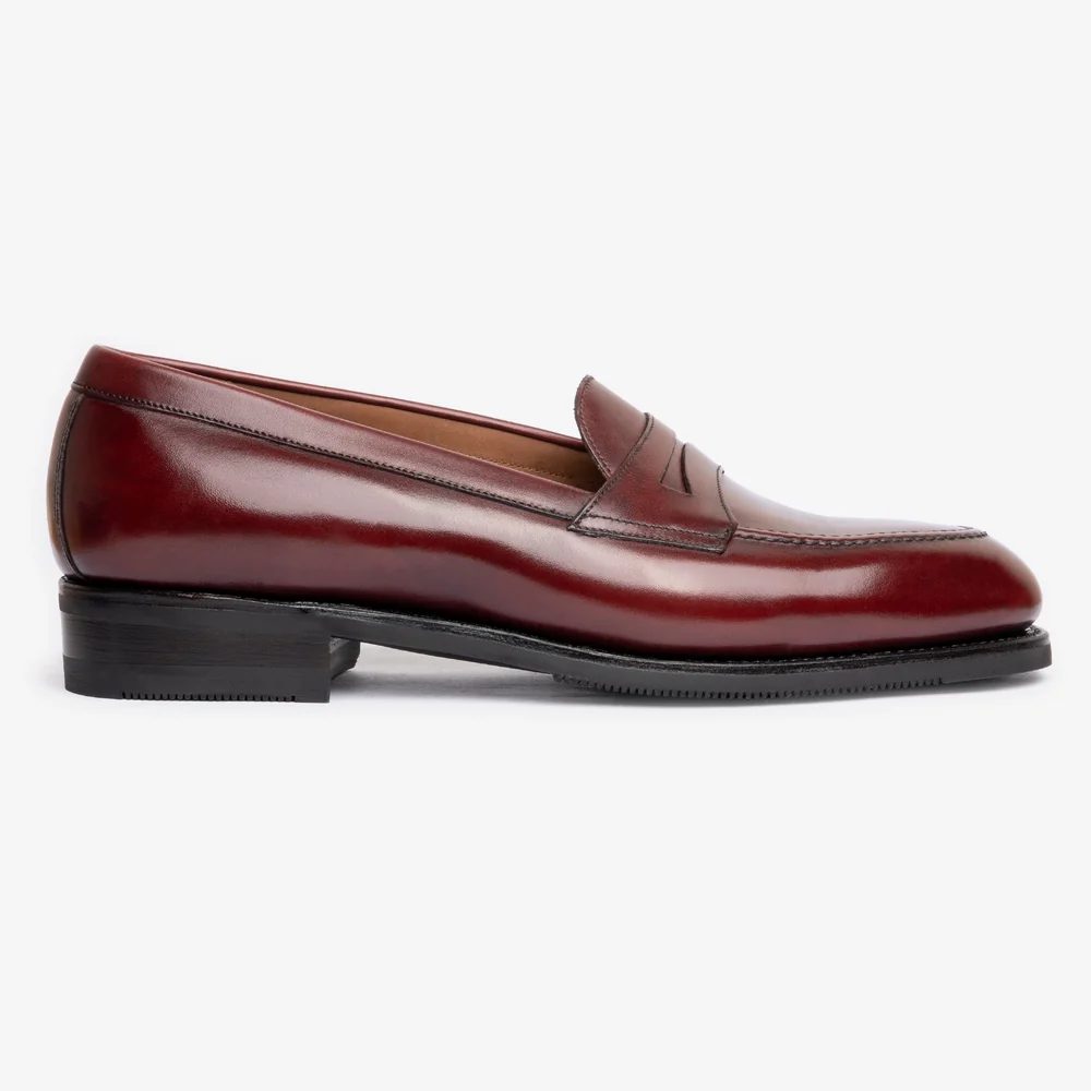 A burgundy leather loafer with a smooth finish and a low black heel.