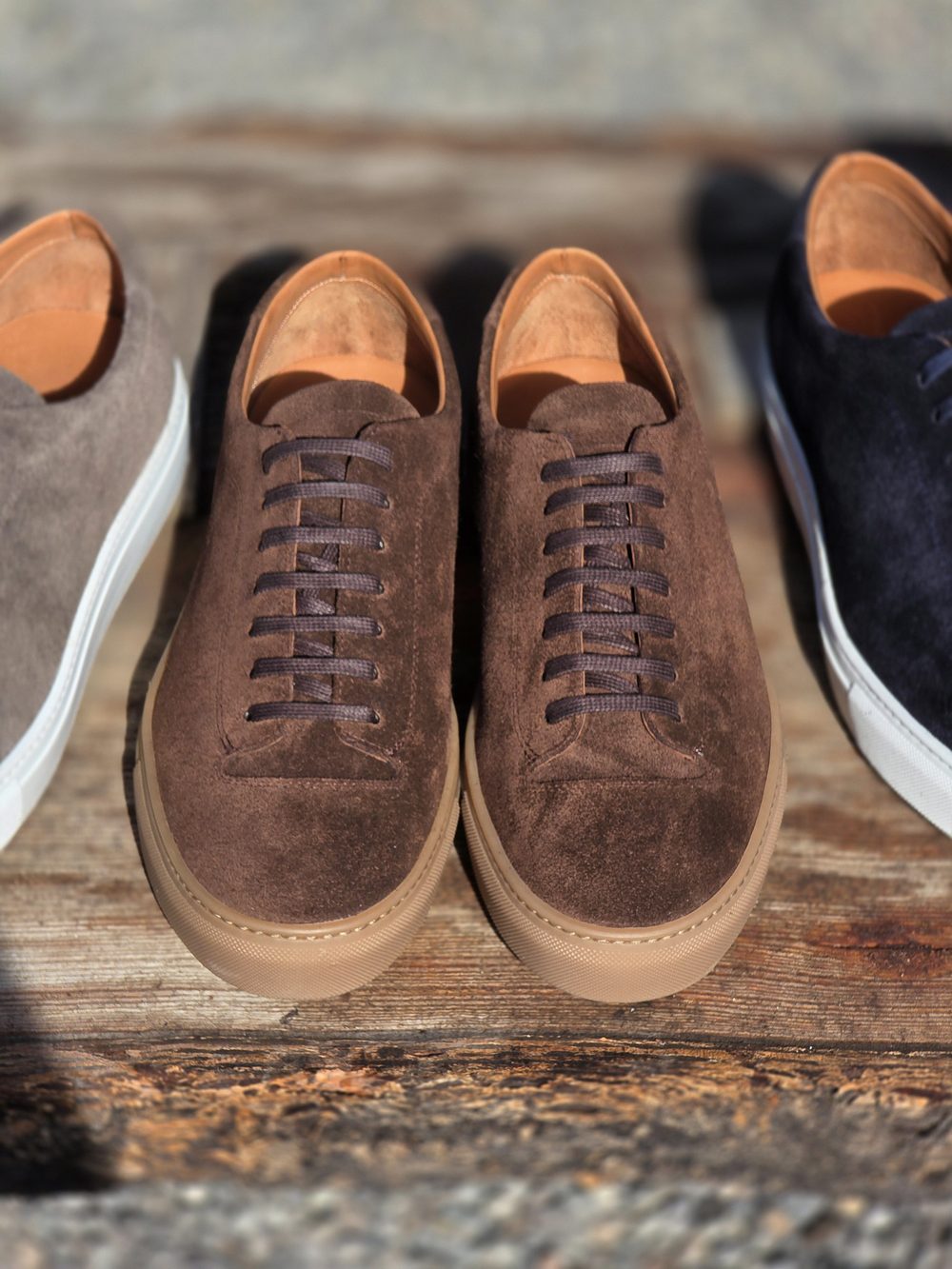 Two pairs of brown suede shoes with brown laces and tan insoles are displayed side by side.