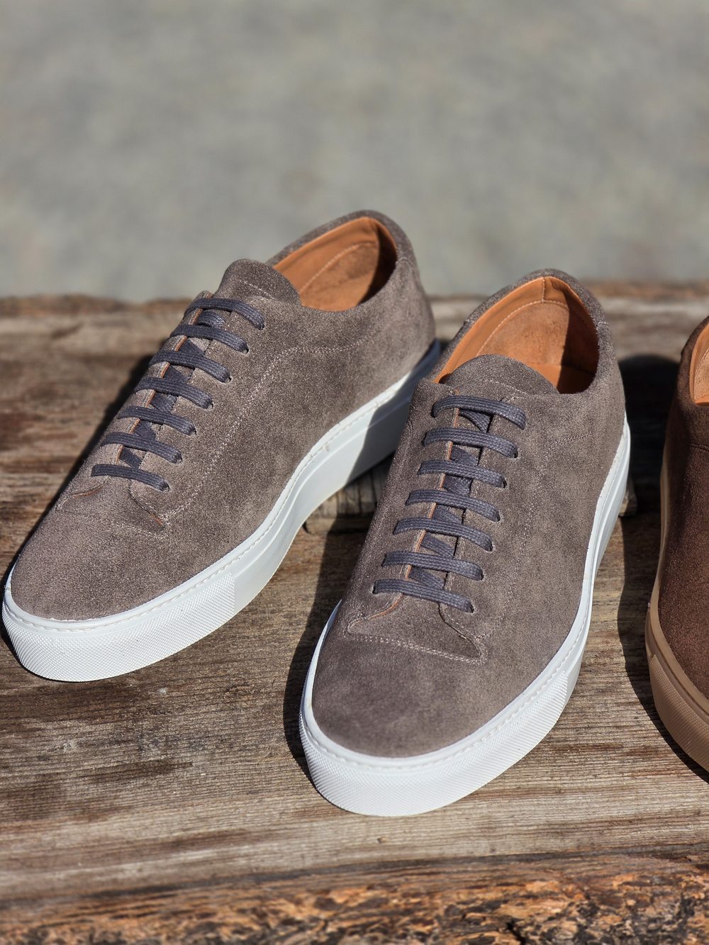 Gray suede sneakers with white rubber soles and gray laces.