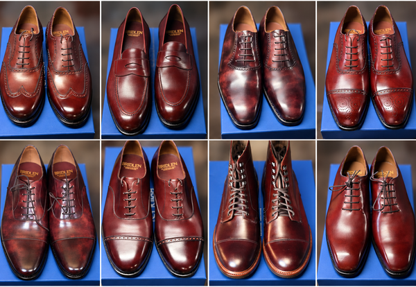 A collection of burgundy leather shoes, including styles like brogues, loafers, and boots, displayed on a blue surface.