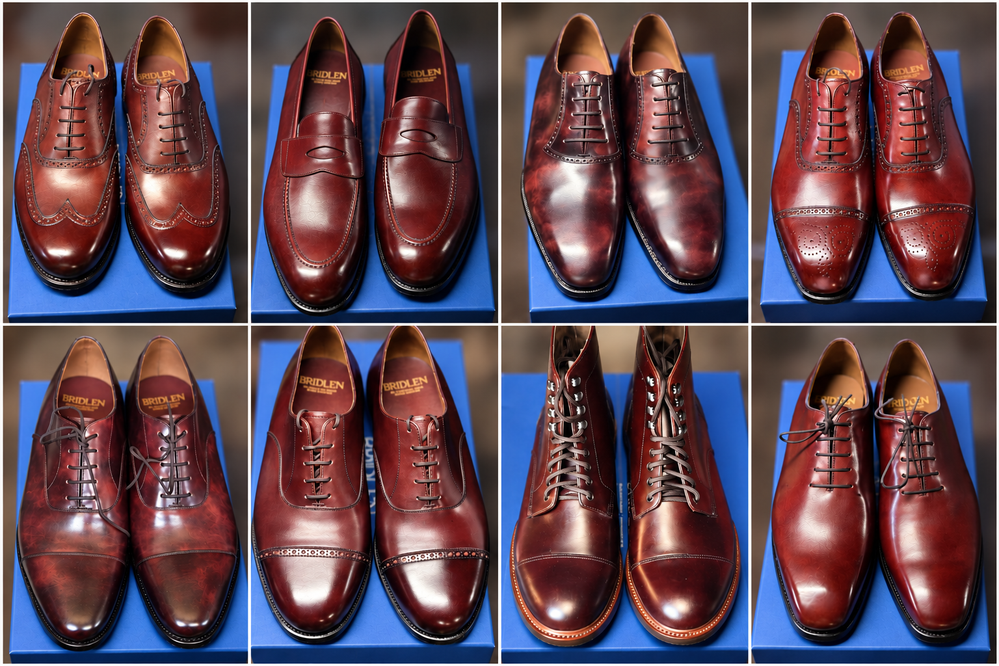 A collection of burgundy leather shoes, including styles like brogues, loafers, and boots, displayed on a blue surface.